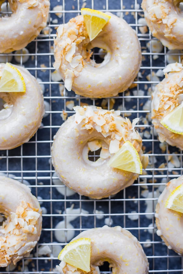 baked vegan lemon coconut donuts on a cooling rack