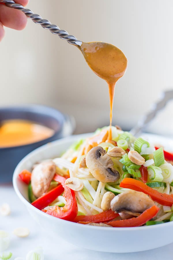 Thai Zucchini Noodle Bowls: A quick 15-minute meal that's gluten free, vegan, and healthy! The creamy nut butter sauce is out-of-this-world! || fooduzzi.com recipes