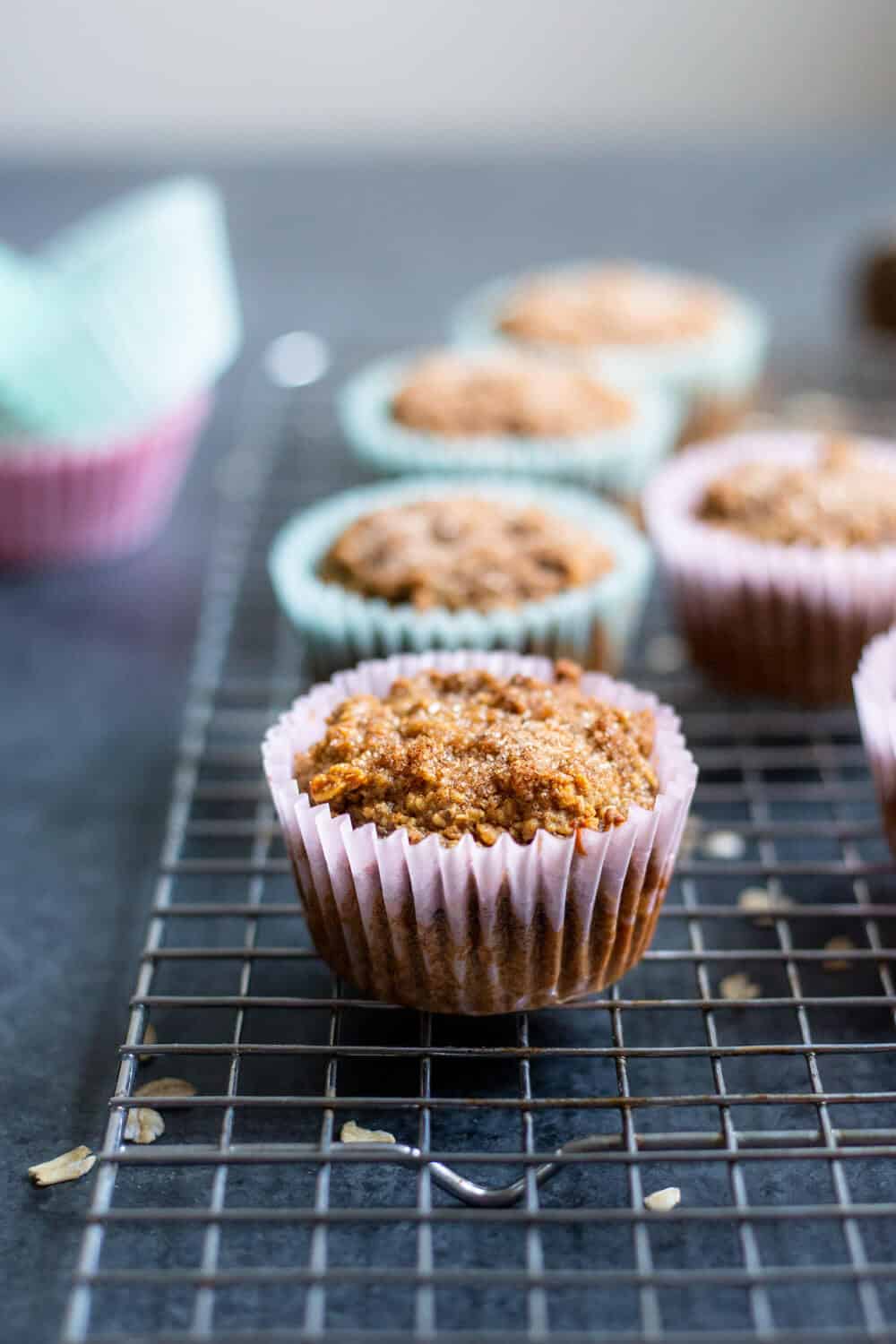 Vegan Blender Apple Spice Muffins in muffin wrappers on a cooling rack
